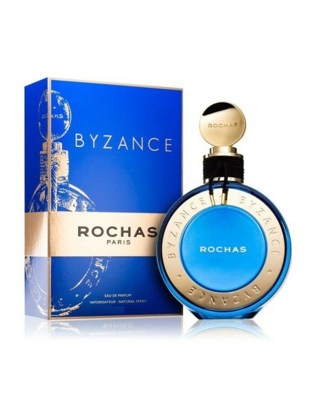 Frasco esférico azul cobalto y oro de Rochas Byzance Eau de Parfum de 60 ml al lado de su estuche oficial.